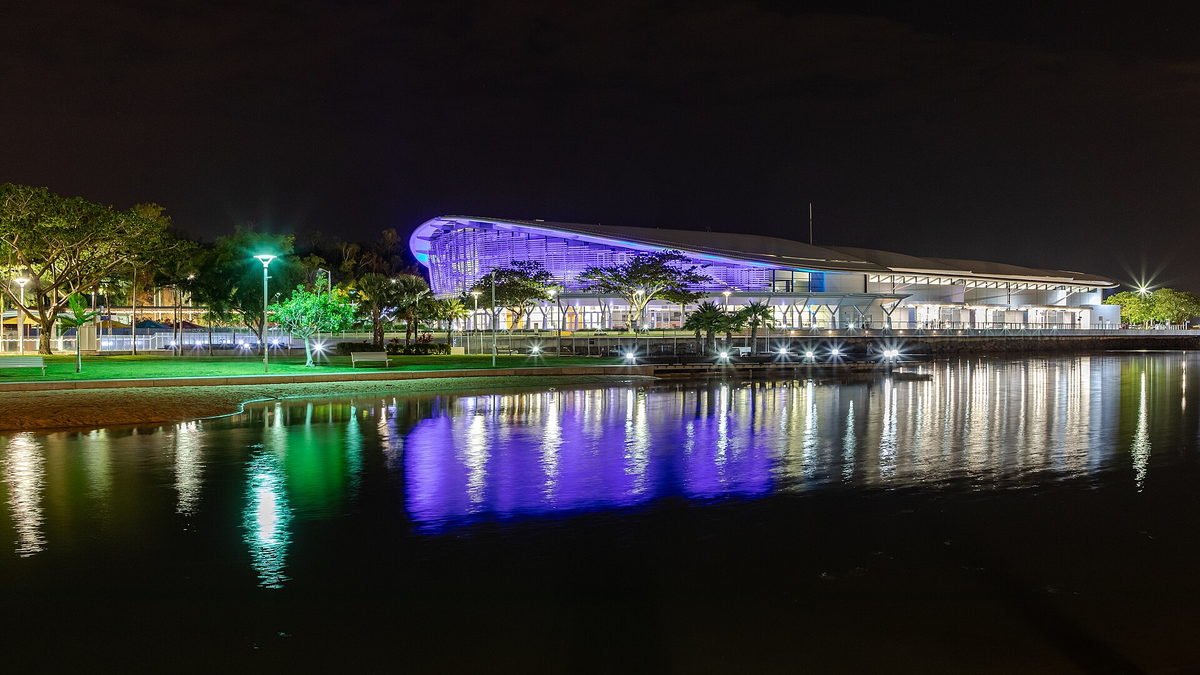 The Darwin waterfront lit at night, reflected in the lagoon