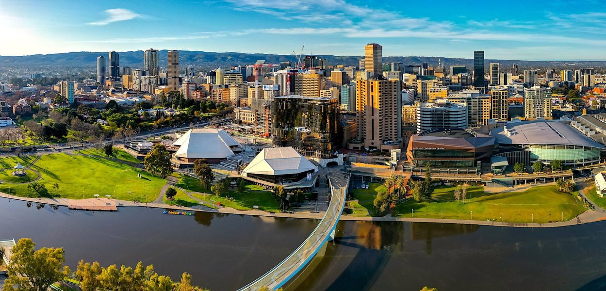 Aerial view of Adelaide's city centre across the River Torrens, with the Adelaide Hills behind