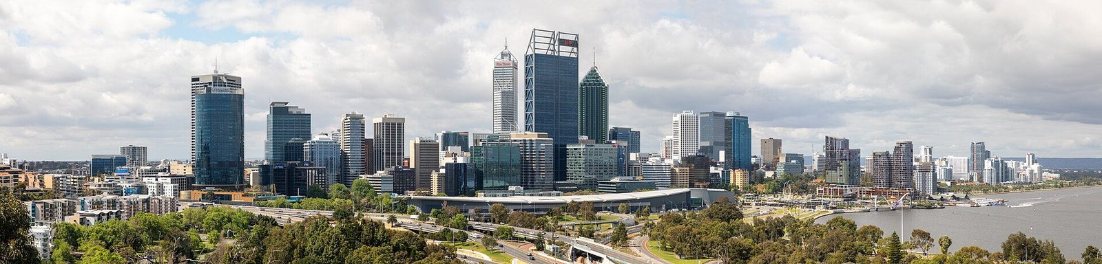 Perth's CBD skyline seen over parkland, with the Swan River to one side
